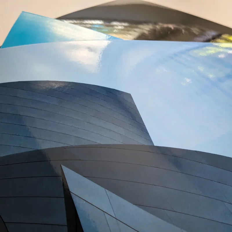 Image of 3 glossy prints with light reflecting off the glossy surface